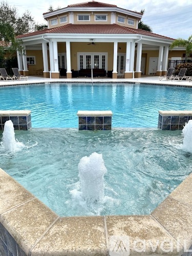 A pool with a house in the background.