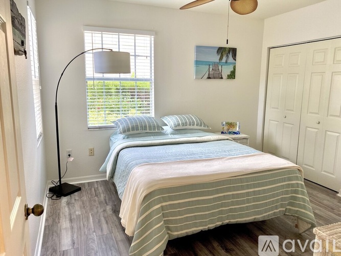 A bedroom with two beds and a ceiling fan.