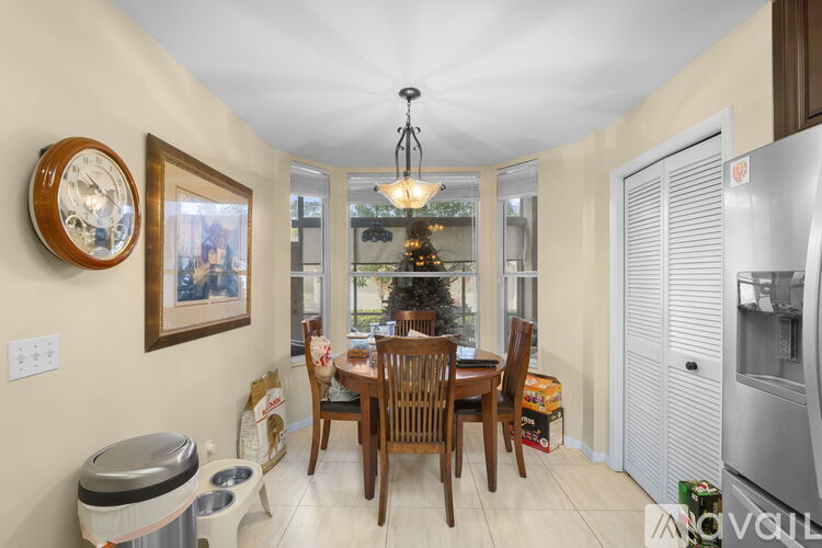 A kitchen with a table and chairs set for a meal.