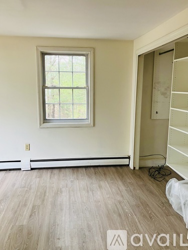 A room with a window and a ladder in it.