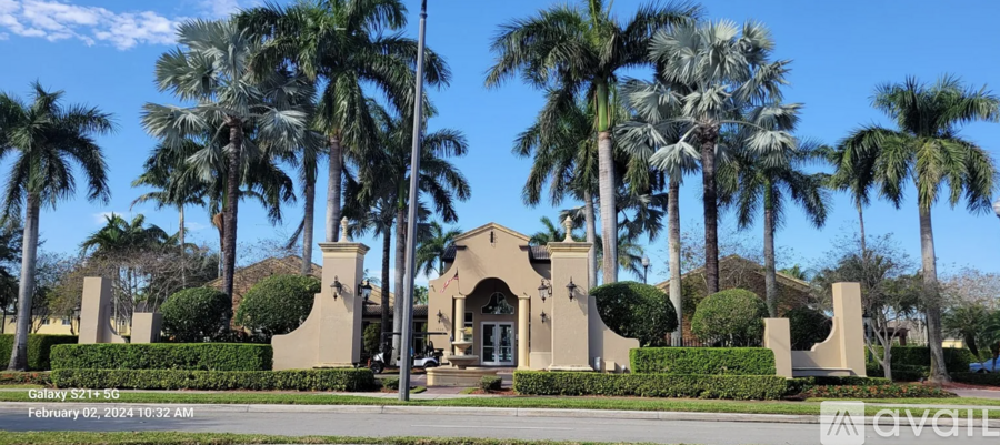 A building with palm trees in front of it.