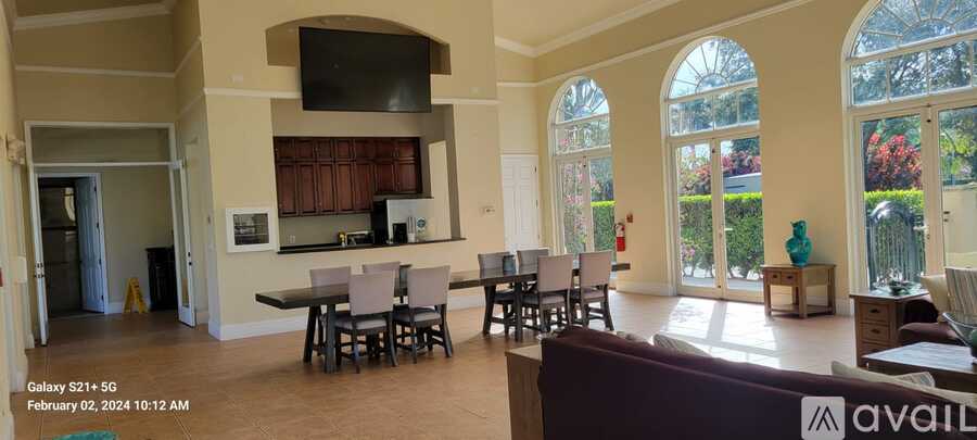 A living room with a large table and chairs.