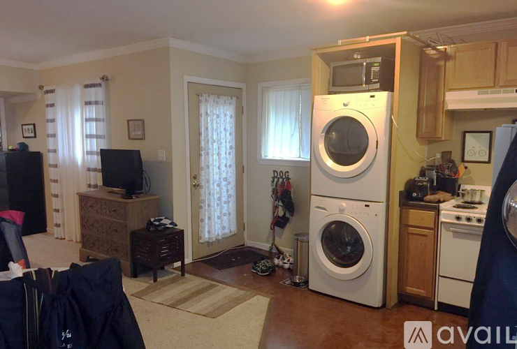 A kitchen with a washer and dryer stacked on top of each other.