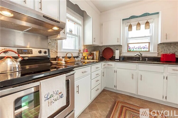 A kitchen with a stove top oven and a sink.
