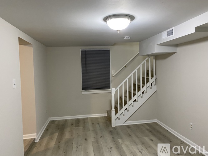 A room with a staircase and a window.