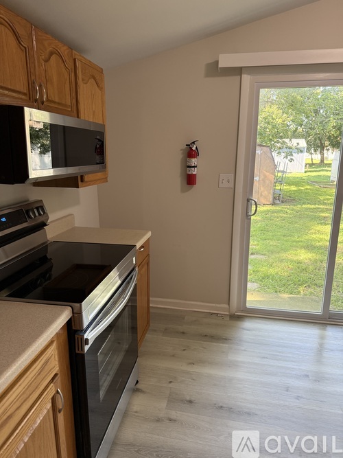 A kitchen with wooden cabinets and a black oven.