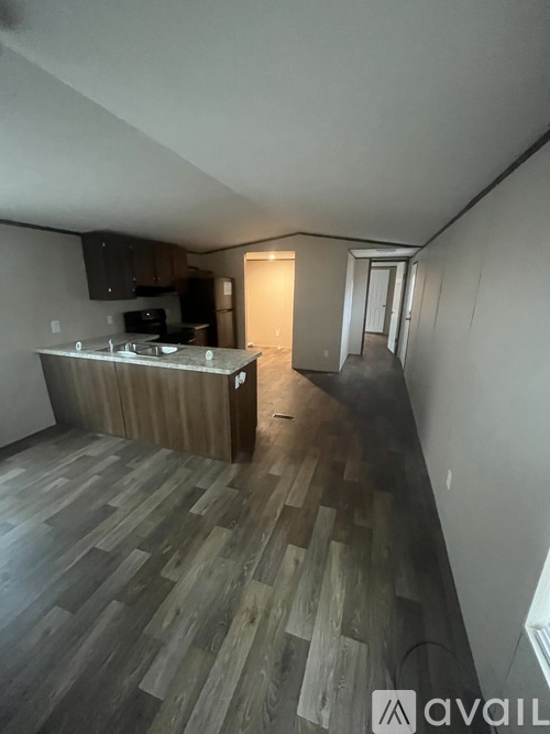 A kitchen with wooden flooring and a countertop.