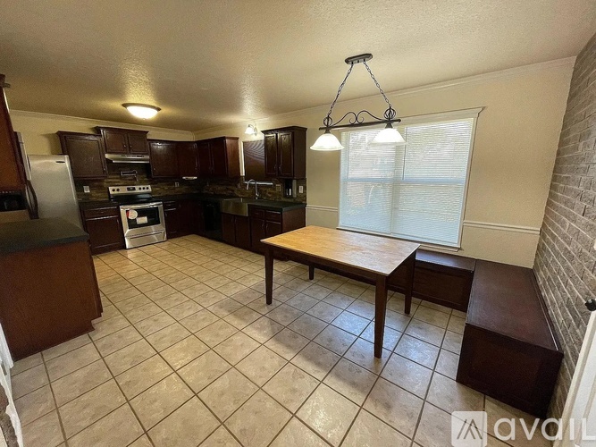 A kitchen with a table and chairs in the middle of the room.