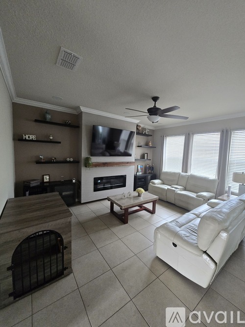A living room with a fireplace, a couch, and a television.