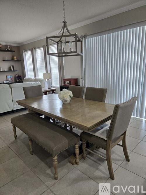 A dining room with a wooden table and chairs.