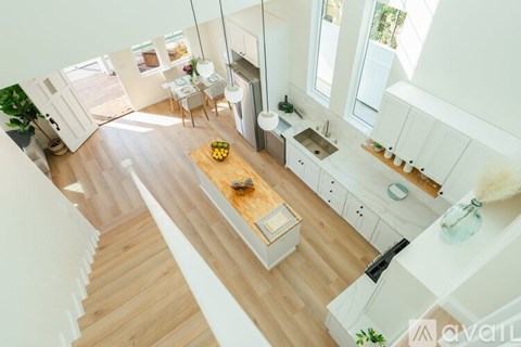 A kitchen with a table and chairs in the middle of the room.