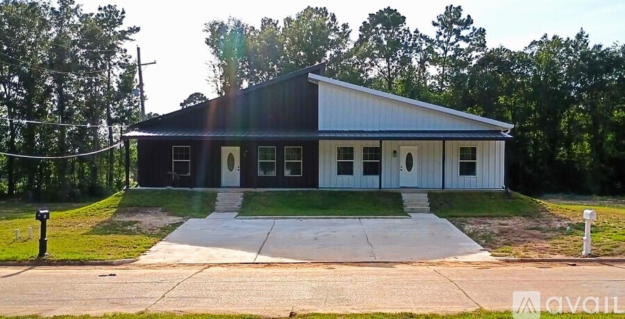 A two-story house with a garage on the side.