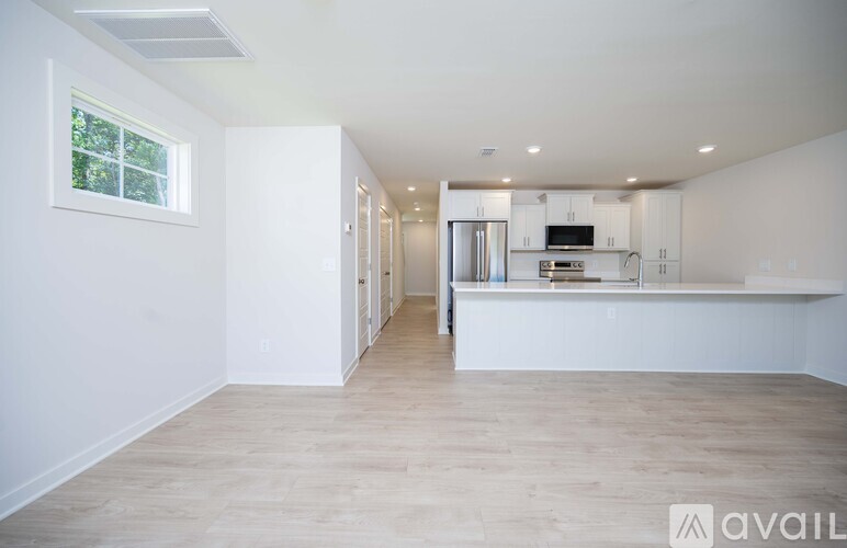 A spacious kitchen with a refrigerator, microwave, and oven.