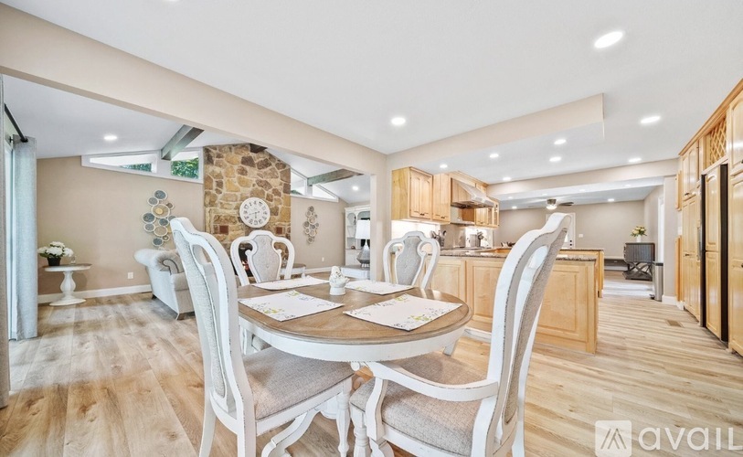 A dining room with a table set for four.