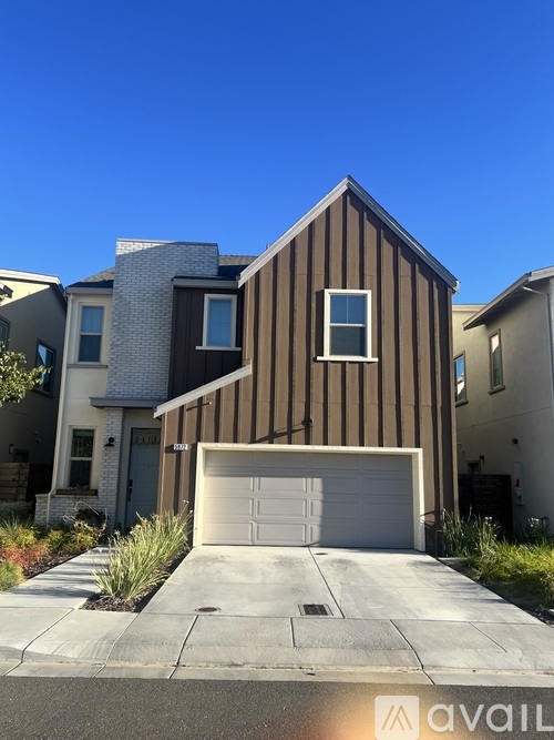 A modern house with a garage is for sale.