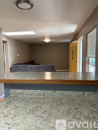 A living room with a grey sofa and a wooden table.