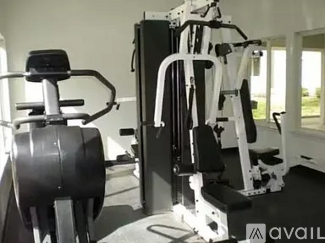 A gym with a weight machine and a treadmill.