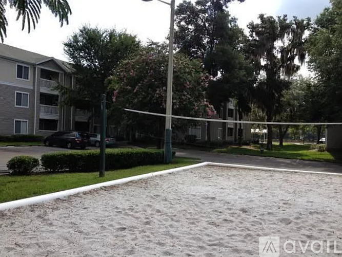 A sandy volleyball court in front of apartment buildings.