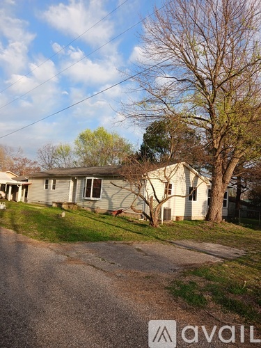 A house with a tree in front of it.