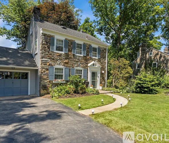 A house with a stone facade and a garage.