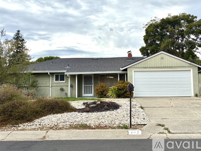 A house with a grey roof and a white garage door.