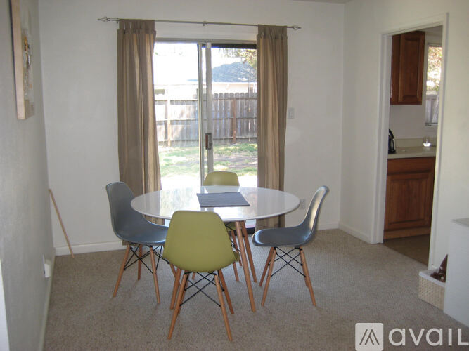 A dining room with a table and chairs.