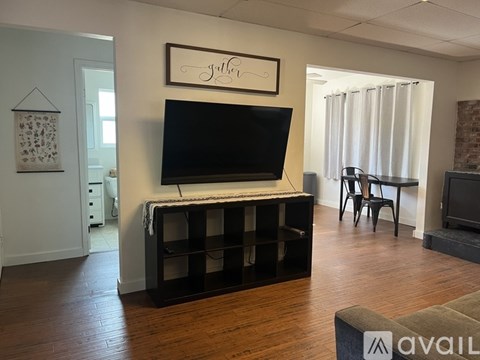 A living room with a television and a couch.