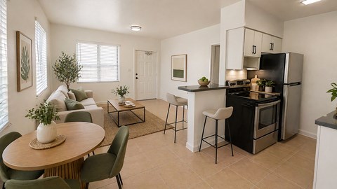 A kitchen with a black refrigerator, white cabinets, and a black stove top oven.