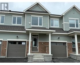 A two-story house with a garage is for sale.