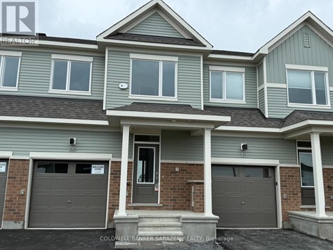 A two-story house with a garage is for sale.