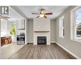 A living room with a fireplace and a ceiling fan.