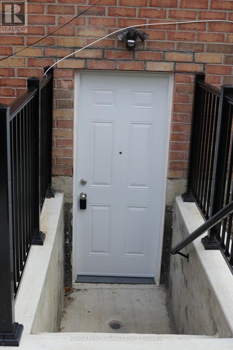 A white door is closed and has a black handle.