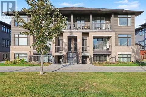 A large apartment building with a tree in front of it.
