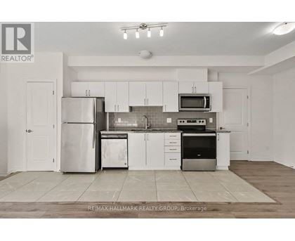 A kitchen with white cabinets and appliances is on the market with RE/MAX Hallmark Realty Group.