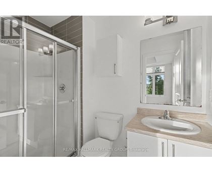 A bathroom with a toilet, sink, and shower.