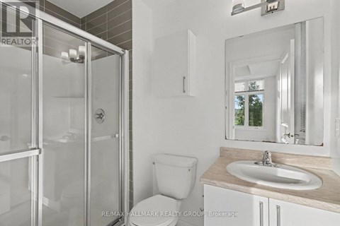 A bathroom with a toilet, sink, and shower.
