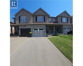 A large house with a driveway in front of it.