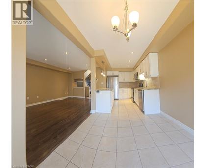 A spacious kitchen with white cabinets and a central island.