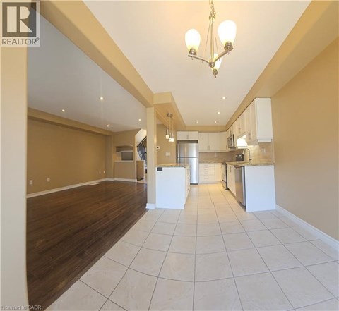 A spacious kitchen with white cabinets and a central island.