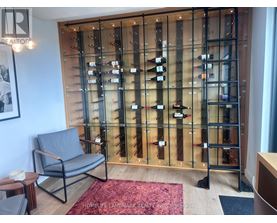 A glass display case with wine bottles in it.