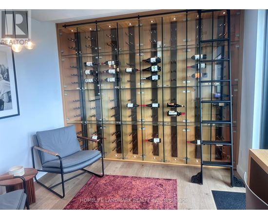 A glass display case with wine bottles in it.