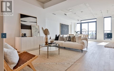 A living room with a white couch and a coffee table.