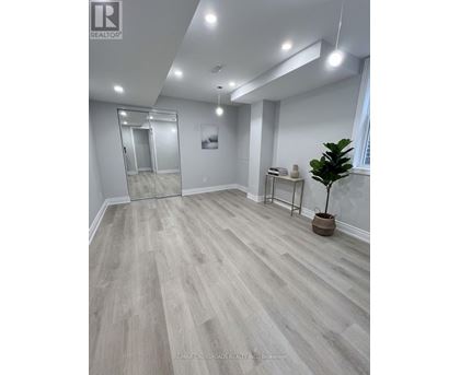 A room with a wooden floor and a glass door.