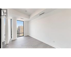 A spacious room with a view of the city through the window.