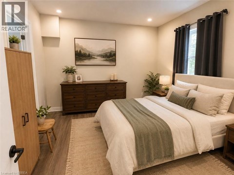 A bedroom with a bed, nightstand, and a painting on the wall.