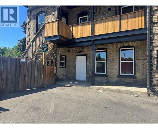 A building with a wooden fence in front of it.