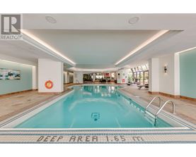 A large indoor swimming pool with a deep area of 16 feet.