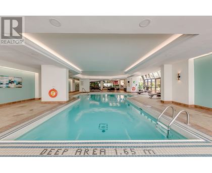 A large indoor swimming pool with a deep area of 16 feet.