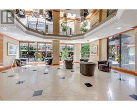 A large open space with a tiled floor and a glass ceiling.