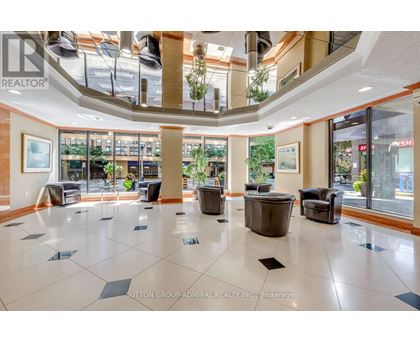 A large open space with a tiled floor and a glass ceiling.